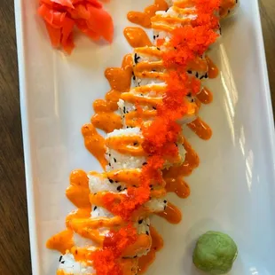 a plate of sushi with sauce on it