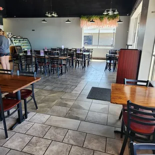 the inside of a restaurant with tables and chairs