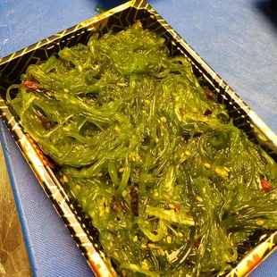 a tray of green vegetables on a table