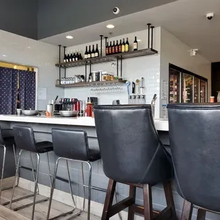 a bar with black leather chairs