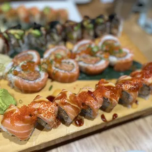 a variety of sushi on a wooden board
