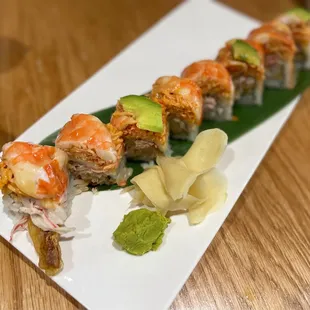 a plate of sushi with shrimp and avocado