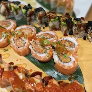 a variety of sushi on a wooden board