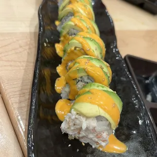 a sushi roll with cheese and avocado