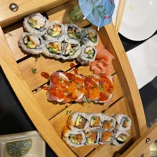 a wooden boat with sushi on it