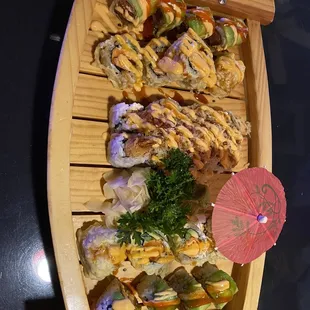 a wooden boat filled with sushi
