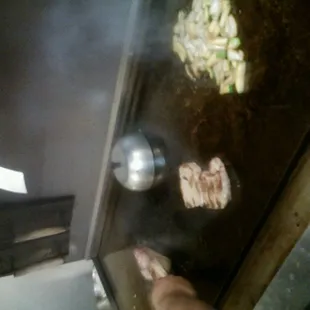 a person cooking food on a grill