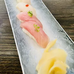 a plate of sushi on a wooden table