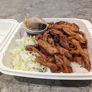 a takeout container of chicken and rice