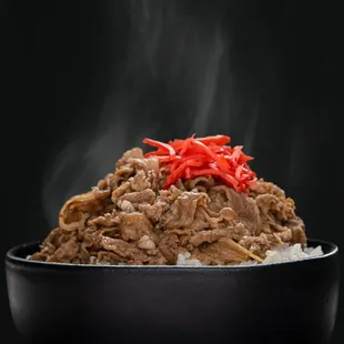 a bowl of rice with meat and vegetables