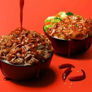 two bowls of food with sauce being drizzled over them