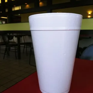 a white cup on a red table