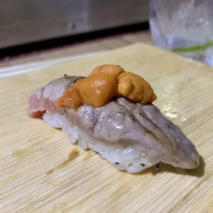 a piece of sushi on a cutting board