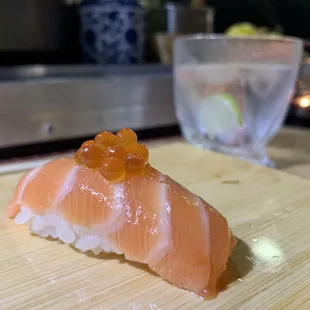 a piece of sushi on a cutting board