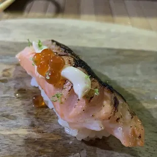 a piece of sushi on a cutting board