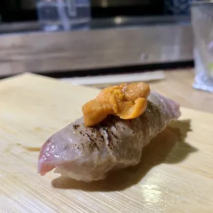 a piece of sushi on a cutting board