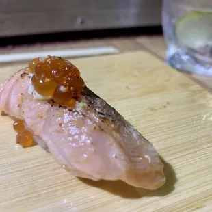 a piece of sushi on a cutting board