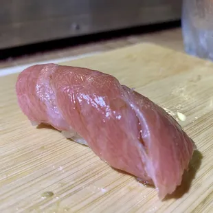 a piece of raw tuna on a cutting board