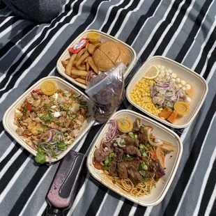 four plates of food on a blanket