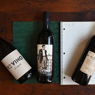 two bottles of wine and a notebook