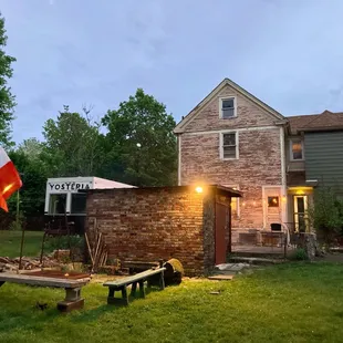 the outside of a house with a picnic table in front of it