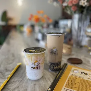 two cups of coffee and a menu