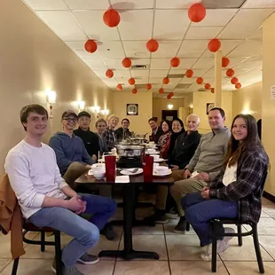 a group of people sitting at a table