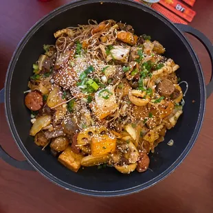 a bowl of noodles and meat