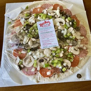 ows a pizza wrapped in plastic