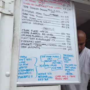 a man standing in front of a menu