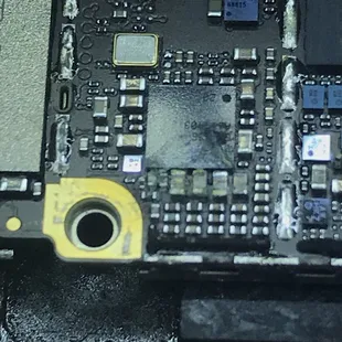iPhone Logic Board: Can you see the corroded caps from liquid damage.