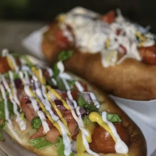 two hot dogs with toppings