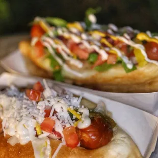 two hot dogs with toppings