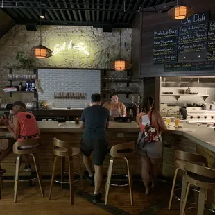 a group of people sitting at a bar