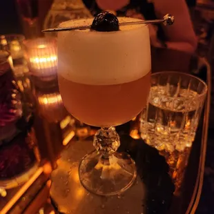 Egg white foam cocktail. I enjoy cocktails with mezcal that have allspice, cinnamon, smokey flavors. Amaretto cherry. Absolutely delicious