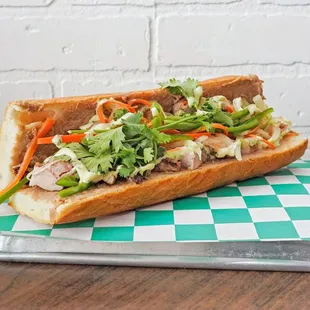 YC Banh Mi

French baguette spread with a hoisin pork butter, five spice grilled chicken, pickled veggies, jalapeño and cilantro aioli