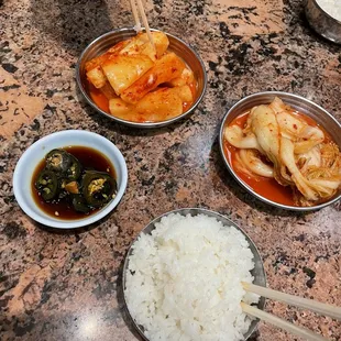Kimchi and rice included with a stew