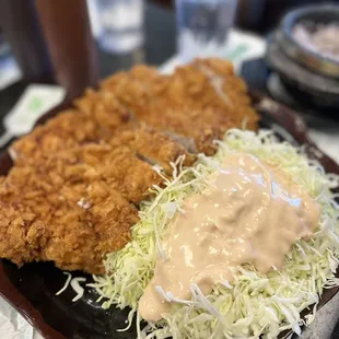 a plate of fried chicken and coleslaw