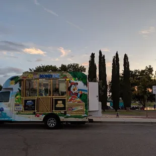 Ice cream truck in front of summer concert.