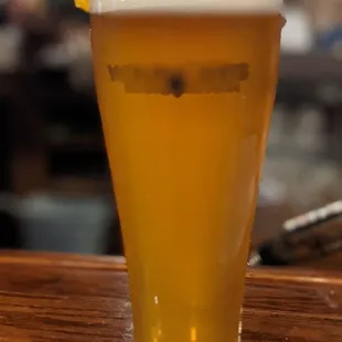 a pint of beer on a bar