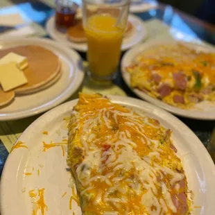 a plate of food and a glass of orange juice