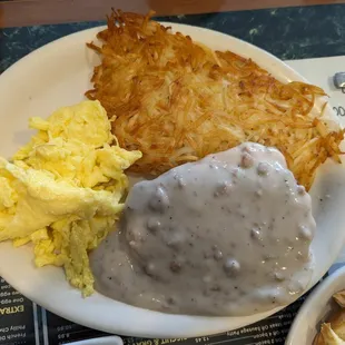 Chicken fried steak with sausage gravy, eggs, and hash brown