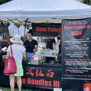 people standing under a tent