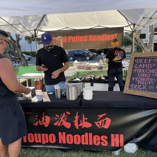Youpo Noodles HI at the Honolulu Farmers Market.  Ward Avenue is in the background.