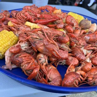 a plate of boiled crawfish and corn