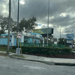 a blue building with a no parking sign