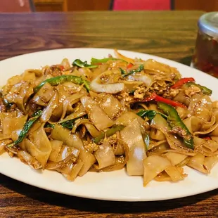 a plate of noodles with meat and vegetables