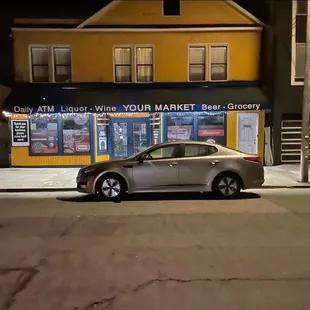 The store owner thinks he owns this 2 car parking spot. He takes up the whole thing to save himself a spot for when he comes in the morning.