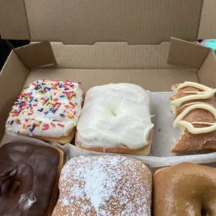Donuts-(from top left) vanilla sprinkles, vanilla bean, cinnamon sugar, chocolate icing, jelly filled, salted caramel.