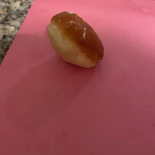 Unevenly fire donut hole that tasted more like oil than a donut hole.